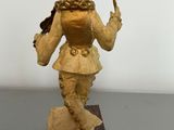 a statue of a woman holding a knife on a table