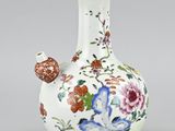 a white vase with a floral design on it