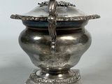 an antique silverplated bowl with a bird on top of it