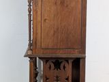 a tall wooden shelf with a clock on top of it