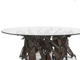 a round glass table with metal legs and a glass top