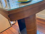 a glass table with a vase on top of it