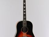an acoustic guitar hanging on a wall in a room