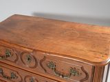 a wooden chest of drawers with brass handles on it