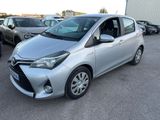 the silver toyota yaris is parked in a parking lot