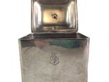 a silver box with a lid on it on a white background