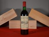 a bottle of wine sitting on a table next to two wooden boxes
