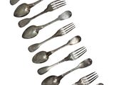 a lot of spoons and forks arranged in a row