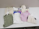 a pile of clothes and a bag on a table