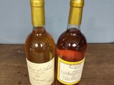 two bottles of wine that are sitting on a table