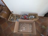 a box full of items sitting on the floor next to a chair