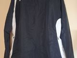 a close up of a black and white jacket hanging on a wall