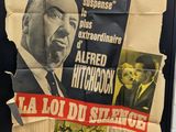 a poster of a man in a suit and tie on a wall