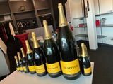 bottles of champagne are lined up on a table in a room