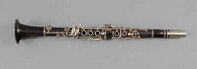 a close up of a clarinet on a white surface