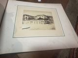 une vieille photo d'une photo d'un bâtiment posé sur une table