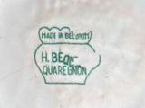 a close up of a white plate with a green design on it
