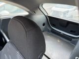 a black seat in the back of a car with a window open