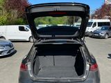 the back of a car with its trunk open in a parking lot