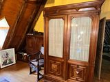 a large wooden cabinet in the corner of a room