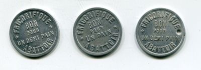 three quarters of the same type of coin are shown on a white surface