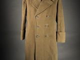 a brown coat on a mannequin stand against a gray background