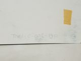 someone is writing on a piece of paper on a table