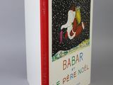 the book is sitting on a white surface with a red border