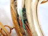 a close up of a saxophone with a person ' s hand on it