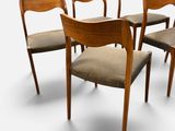 four wooden chairs with upholstered cushions and a beige seat