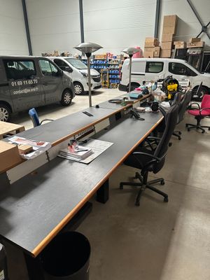 a long table in the middle of a room with a van in the background