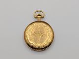 an image of a gold pocket watch sitting on top of a white surface