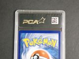 the pokemon card is in the plastic case on the table