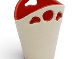 a white vase with red handles on a white surface
