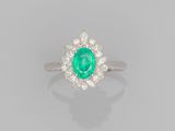 an emerald and diamond cluster ring