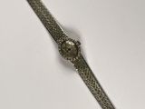 an image of a wrist watch on a white surface with a white background