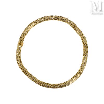 gros plan d'un bracelet en or sur fond blanc