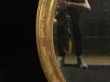 a man standing in front of a mirror with his reflection in it