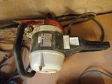 a small blower sitting on the floor next to wires