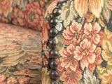 a close up of the back of a floral upholstered chair