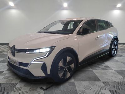 La voiture blanche est garée dans la pièce, sur un sol à carreaux.
