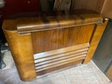 an old radio that is sitting in the corner of a room
