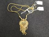 gold plated necklace with a heart shaped pendant on a gold chain