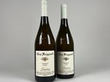 two bottles of wine sitting next to each other on a table