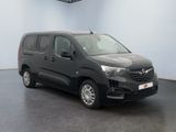 the black van is parked in a room with a white wall