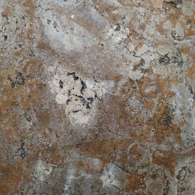 a close up of a stone surface with a brown and white color
