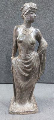 bronze statue of a woman with a dress and a hat