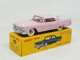 pink toy car sitting on top of a box on a white surface