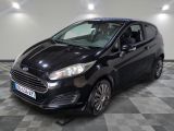 the black ford fiesta is parked in a large room