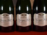 three bottles of champagne sitting on a table next to each other